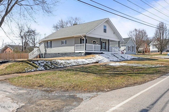 view of front of home featuring crawl space, covered porch, fence, and a front lawn