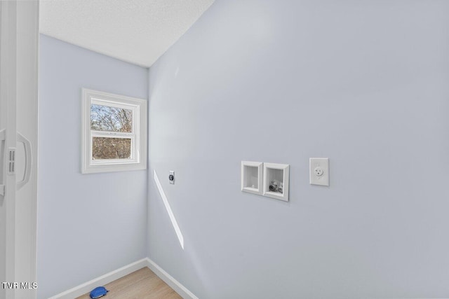 washroom featuring hookup for a washing machine, hookup for an electric dryer, a textured ceiling, laundry area, and baseboards