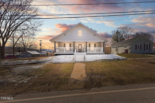 view of front facade with covered porch and a yard