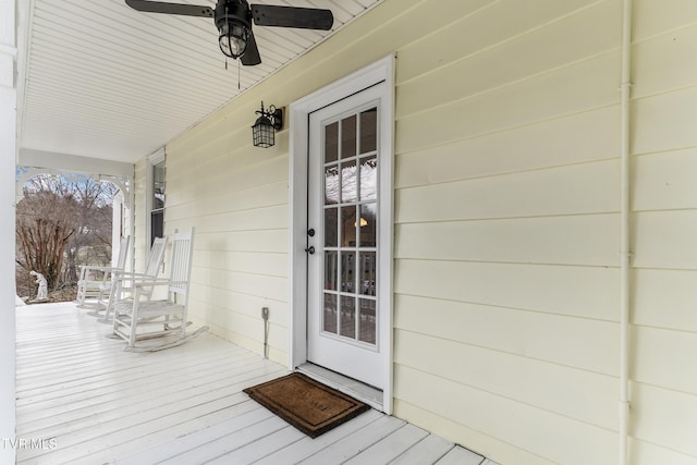 view of exterior entry featuring covered porch