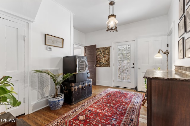 foyer entrance with light wood-type flooring, visible vents, and baseboards