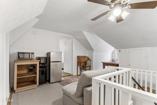 bedroom featuring lofted ceiling, ceiling fan, and freestanding refrigerator