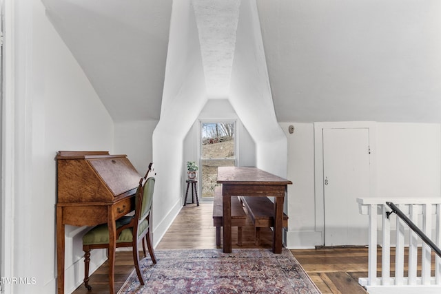 office featuring lofted ceiling, wood finished floors, and baseboards