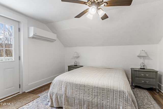 bedroom featuring baseboards, ceiling fan, dark wood-type flooring, vaulted ceiling, and an AC wall unit