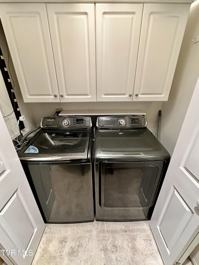 laundry room with washer and dryer and cabinet space