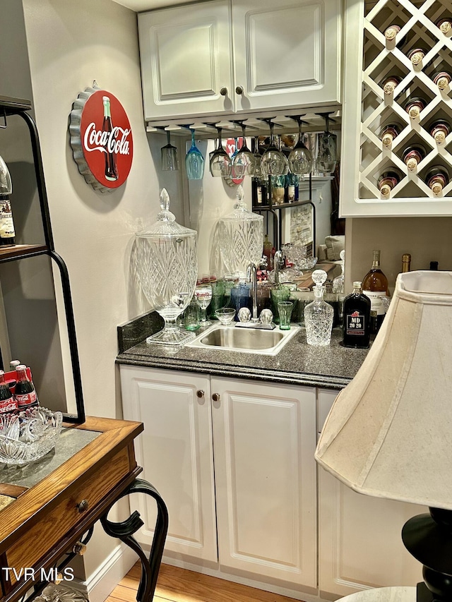 bar featuring indoor wet bar and a sink