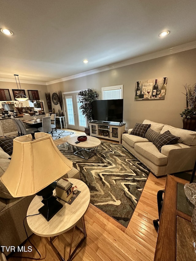 living room featuring ornamental molding, wood finished floors, and recessed lighting