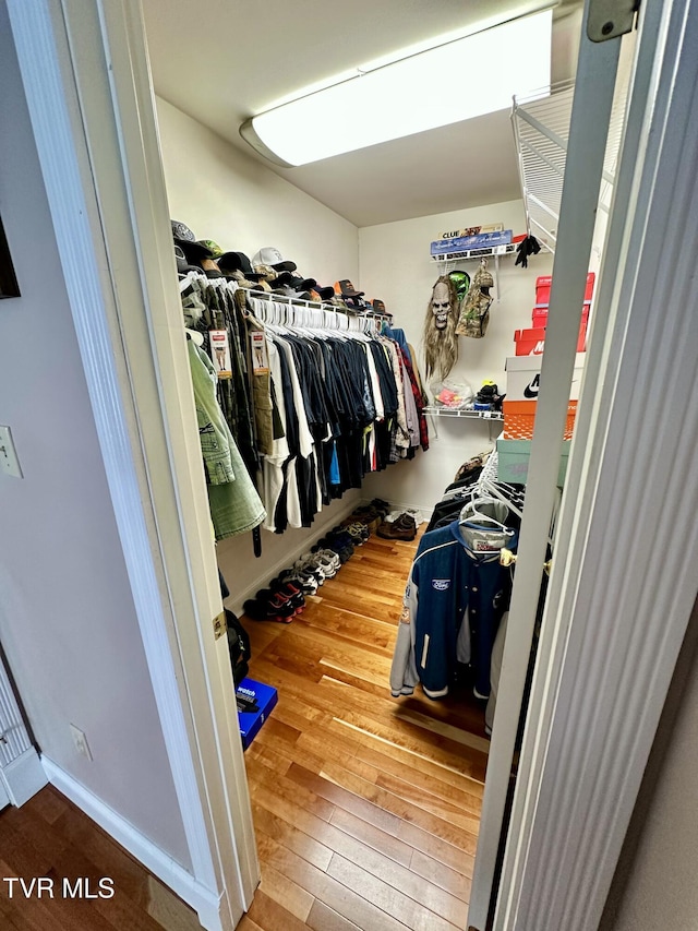 walk in closet with hardwood / wood-style floors