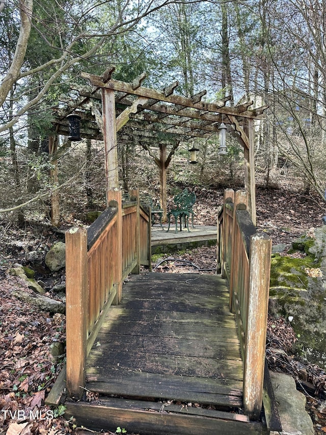 wooden deck featuring a pergola