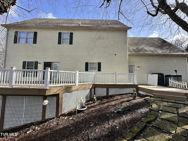 rear view of property with a deck and central air condition unit