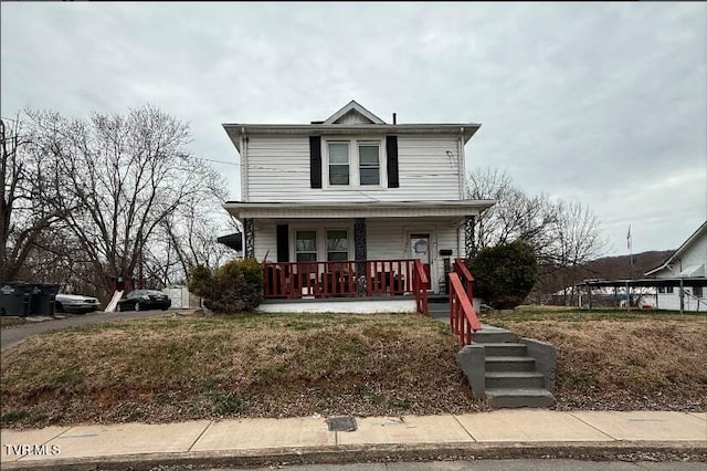 american foursquare style home featuring covered porch