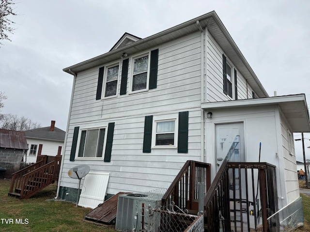 back of property featuring central AC unit