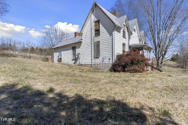 view of property exterior featuring a chimney