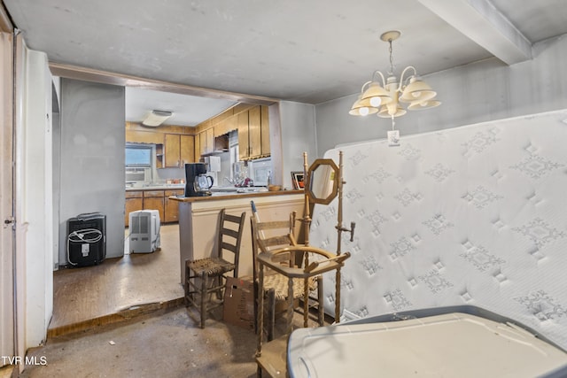 kitchen with decorative light fixtures, brown cabinetry, unfinished concrete floors, a chandelier, and a peninsula