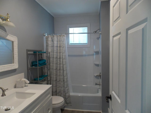 bathroom featuring toilet, shower / bathtub combination with curtain, and vanity