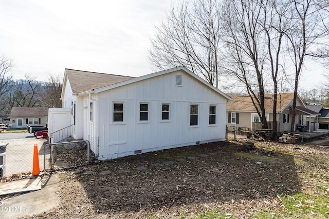 204 Johnston Ave, Bristol, TN 37620 - view of home's exterior with board and batten siding, a shingled roof, crawl space, and fence