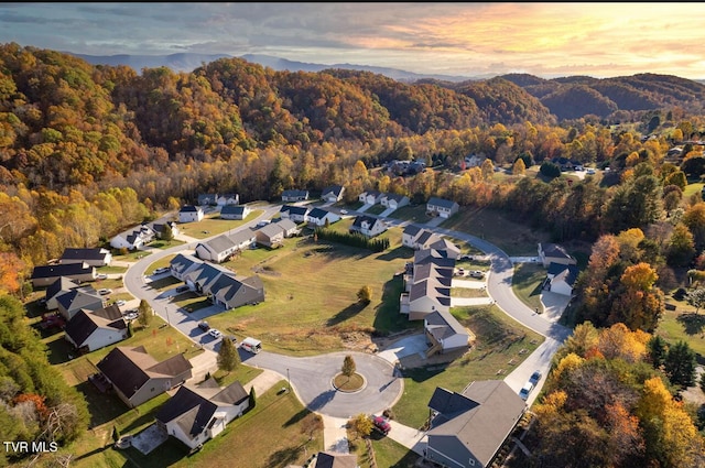 aerial view at dusk featuring a residential view