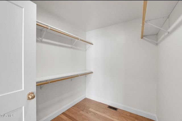 walk in closet with visible vents and wood finished floors