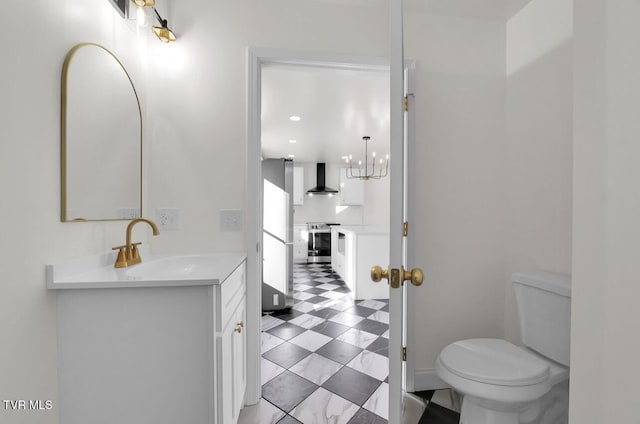 half bathroom featuring vanity, toilet, and tile patterned floors