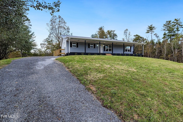 view of front of property featuring a porch, driveway, and a front lawn