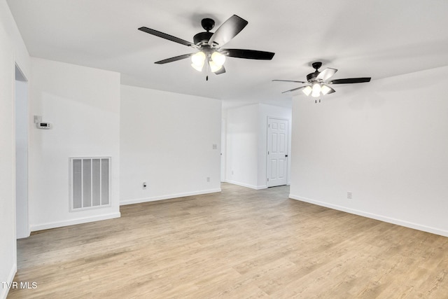 empty room with light wood finished floors, baseboards, visible vents, and a ceiling fan