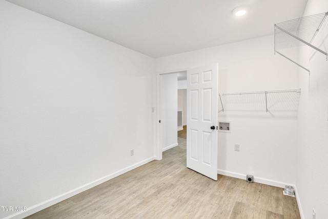 washroom featuring washer hookup, light wood-style floors, electric dryer hookup, laundry area, and baseboards