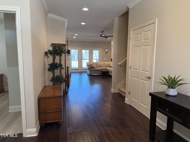 hall featuring dark wood-style floors, ornamental molding, stairway, and recessed lighting