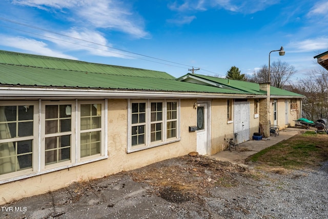 view of property exterior featuring metal roof and stucco siding