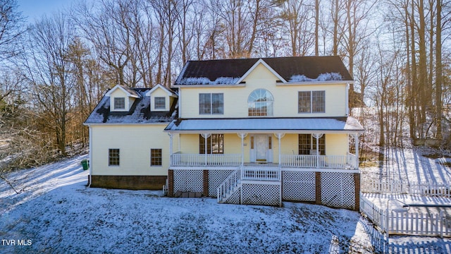 view of front of home with covered porch and stairs