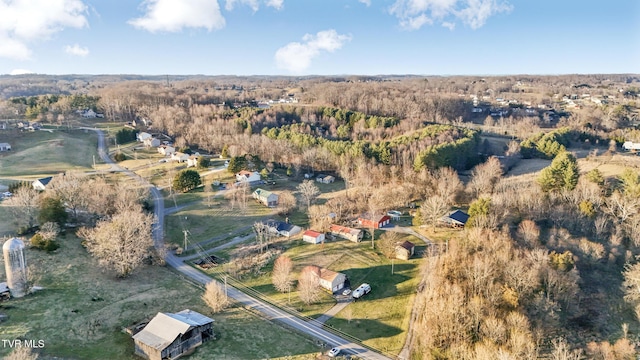 birds eye view of property featuring a view of trees