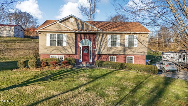 bi-level home featuring brick siding and a front yard