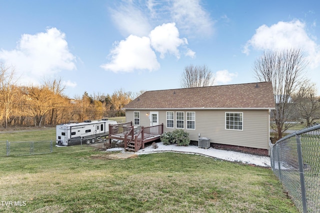 back of house featuring central air condition unit, a fenced backyard, a deck, and a yard