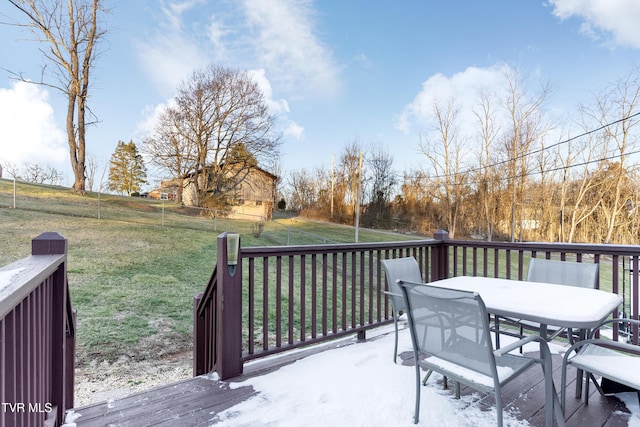 wooden deck with a lawn and outdoor dining space