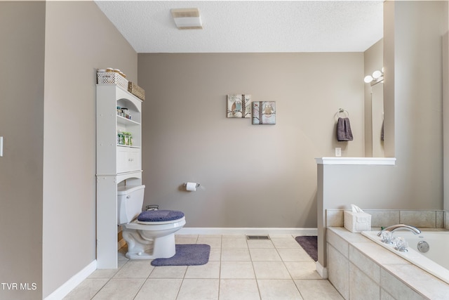 bathroom featuring a textured ceiling, toilet, tile patterned flooring, and a garden tub