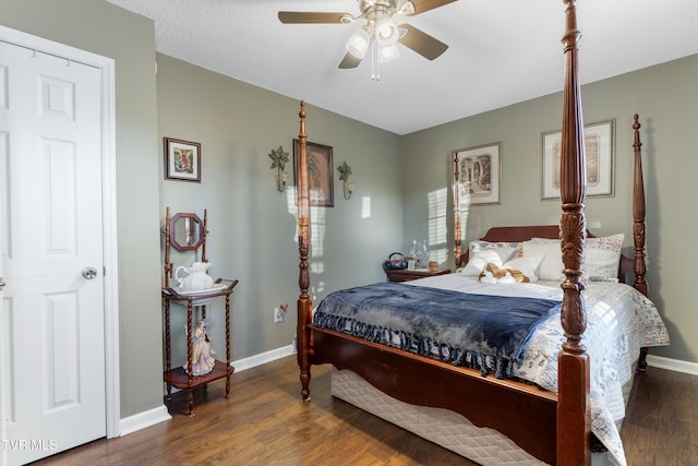 bedroom featuring ceiling fan, baseboards, and wood finished floors