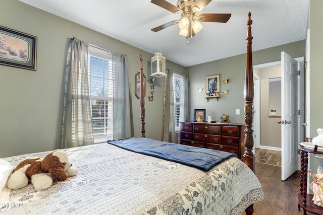 bedroom featuring a textured ceiling, a ceiling fan, and wood finished floors