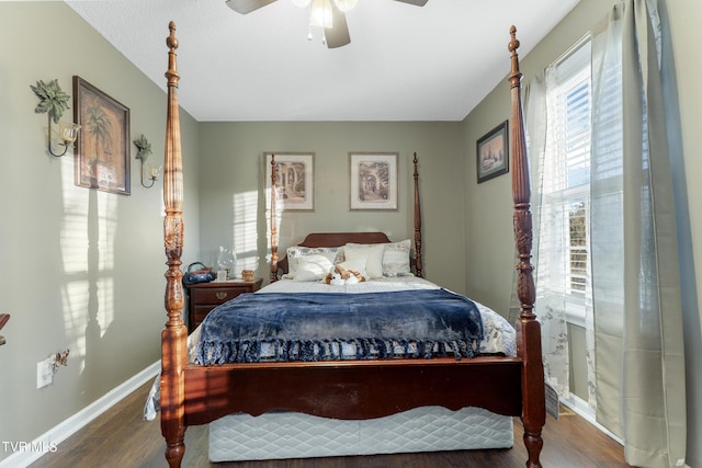 bedroom featuring a ceiling fan, baseboards, and wood finished floors