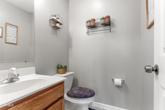 bathroom with toilet and vanity