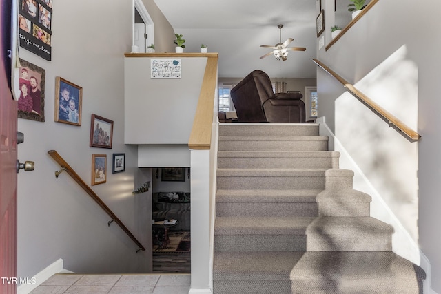 stairs with ceiling fan and tile patterned floors