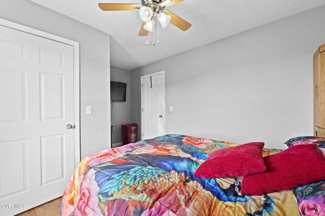 bedroom with ceiling fan and wood finished floors