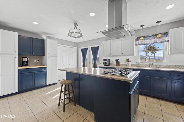kitchen with a kitchen island, white cabinets, a sink, and island range hood