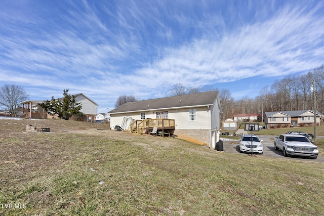 rear view of property with a residential view, a yard, and a wooden deck