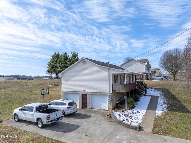 view of property exterior featuring a garage, driveway, and a porch