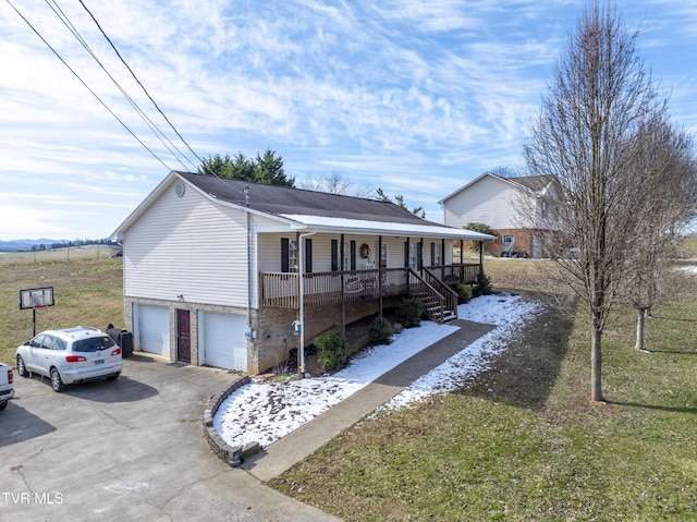 ranch-style house with a garage, driveway, a porch, and a front yard
