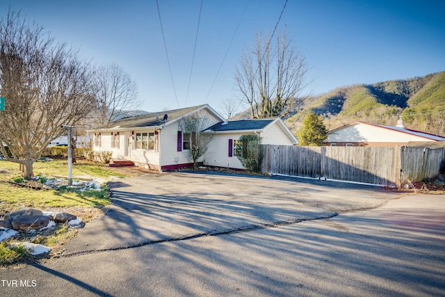 view of front of home with fence and a mountain view