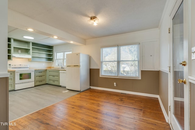 kitchen featuring under cabinet range hood, white appliances, light countertops, open shelves, and green cabinetry