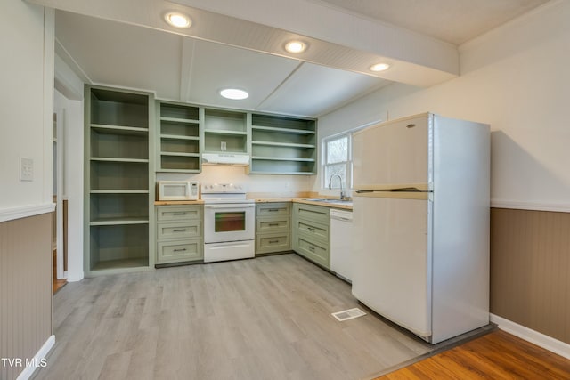 kitchen with open shelves, light countertops, green cabinets, white appliances, and under cabinet range hood