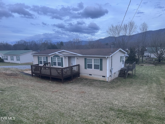 view of front of property featuring a shingled roof, a front yard, crawl space, and a deck