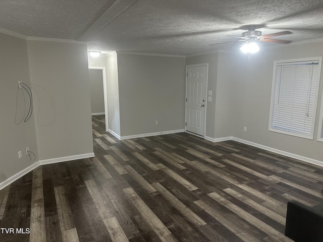 empty room featuring dark wood-style flooring, crown molding, a textured ceiling, and baseboards