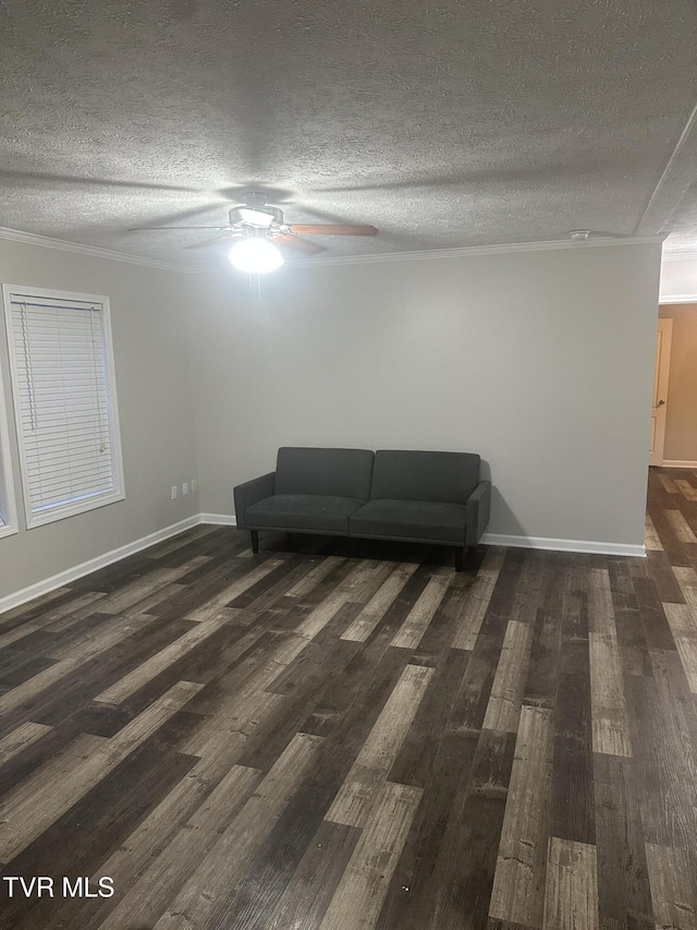 unfurnished room featuring ceiling fan, a textured ceiling, wood finished floors, and baseboards